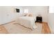 Bright main bedroom featuring stylish lamps, a cozy bed, and hardwood floors with a decorative rug at 2257 S Lowell Blvd, Denver, CO 80219