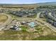 An aerial view of the community shows the pool, clubhouse, playground, and well-maintained landscaping in a Gathering-friendly neighborhood at 11053 Bright Sky Cir, Littleton, CO 80125