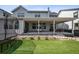 This backyard features a patio with outdoor seating, a trampoline, and an artificial lawn surrounded by rocks at 11053 Bright Sky Cir, Littleton, CO 80125
