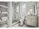Modern bathroom with a glass-enclosed shower, neutral colors and a floating shelf at 11053 Bright Sky Cir, Littleton, CO 80125
