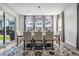 Dining room with a modern chandelier, large windows, and an patterned area rug at 11053 Bright Sky Cir, Littleton, CO 80125