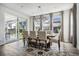 Bright dining room with a modern chandelier, large windows, and a sliding glass door to the patio at 11053 Bright Sky Cir, Littleton, CO 80125