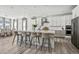 Gourmet kitchen with a large island, modern appliances, and dining area at 11053 Bright Sky Cir, Littleton, CO 80125