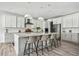 Bright kitchen features modern appliances, a large island with seating, and ample cabinets at 11053 Bright Sky Cir, Littleton, CO 80125