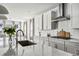 Modern kitchen featuring white cabinets, stainless steel appliances, and marble countertops at 11053 Bright Sky Cir, Littleton, CO 80125