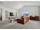 Spacious living room featuring a vaulted ceiling, large windows, and a leather couch at 11053 Bright Sky Cir, Littleton, CO 80125