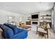 Bright living room features fireplace, open shelving, and comfortable seating at 11053 Bright Sky Cir, Littleton, CO 80125