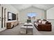Spacious living room with high ceilings, cozy seating, and large window providing great natural light at 11053 Bright Sky Cir, Littleton, CO 80125