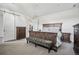 Comfortable main bedroom with carpet, dresser, and a luxurious upholstered bedframe at 11053 Bright Sky Cir, Littleton, CO 80125