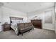 Comfortable main bedroom with carpet, dresser, and a luxurious upholstered bedframe at 11053 Bright Sky Cir, Littleton, CO 80125