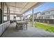 View of a patio that includes a table and chairs, a well-maintained lawn, and an exterior view of other houses at 11053 Bright Sky Cir, Littleton, CO 80125