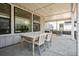This cozy patio includes a table and chairs plus a large window in the background to provide ample light at 11053 Bright Sky Cir, Littleton, CO 80125