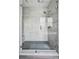 Modern glass enclosed shower with tiled walls and rainfall shower head at 11053 Bright Sky Cir, Littleton, CO 80125