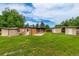 The backyard showcases an expansive lawn, mature trees, and additional outbuildings at 1016 Stearns Ave, Boulder, CO 80303
