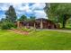 Charming home with a covered patio, beautiful landscaping, and a lush green lawn at 1016 Stearns Ave, Boulder, CO 80303