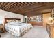Bedroom with carpet floors, wood ceiling, built-in bookcase, and ensuite bathroom at 1016 Stearns Ave, Boulder, CO 80303