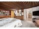 Bedroom with floral bedspread, wood ceiling, built-in bookcase, and ensuite bathroom at 1016 Stearns Ave, Boulder, CO 80303