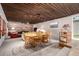 Warm dining space with wood ceiling, and adjacent living area with a stylish brick fireplace at 1016 Stearns Ave, Boulder, CO 80303