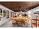 Cozy dining room with wood ceiling, exposed brick accent wall and large windows for natural light at 1016 Stearns Ave, Boulder, CO 80303