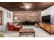 Comfortable living room features stone accent wall, ceiling fan, and carpet flooring at 1016 Stearns Ave, Boulder, CO 80303