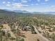 A beautiful home has many tall evergreen trees and is set on a large private lot at 30444 Ruby Ranch Rd, Evergreen, CO 80439