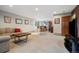 Finished basement with a comfortable seating area and entertainment space at 30444 Ruby Ranch Rd, Evergreen, CO 80439