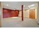 Finished basement space with carpet and painted accent wall at 30444 Ruby Ranch Rd, Evergreen, CO 80439