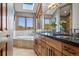 Bathroom features a dual sink vanity, soaking tub, and granite countertops at 30444 Ruby Ranch Rd, Evergreen, CO 80439