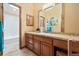 Bathroom featuring a tiled floor, wood vanity, undermount sink and adjacent lavatory at 30444 Ruby Ranch Rd, Evergreen, CO 80439