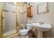 Bathroom featuring glass enclosed shower, sink with pedestal and dark wood cabinetry at 30444 Ruby Ranch Rd, Evergreen, CO 80439