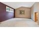 Spacious bedroom featuring neutral carpet, vaulted ceiling, and picture window at 30444 Ruby Ranch Rd, Evergreen, CO 80439