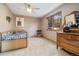 Comfortable bedroom with ceiling fan, dresser, and a window with a view at 30444 Ruby Ranch Rd, Evergreen, CO 80439