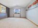 Cozy bedroom featuring picture window, carpet, and neutral paint at 30444 Ruby Ranch Rd, Evergreen, CO 80439