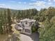 Stunning two-story home nestled among the trees with a covered entrance and attached two car garage at 30444 Ruby Ranch Rd, Evergreen, CO 80439