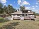 This home features a large deck and patio with a hot tub and multiple windows at 30444 Ruby Ranch Rd, Evergreen, CO 80439