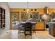 Eat-in kitchen boasting stainless steel appliances, modern lighting, and an adjacent outdoor dining area at 30444 Ruby Ranch Rd, Evergreen, CO 80439