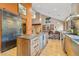 Contemporary kitchen showcasing stainless steel appliances, island with seating, and sliding barn door entry at 30444 Ruby Ranch Rd, Evergreen, CO 80439