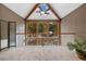 Living area with vaulted ceiling, clerestory windows and exterior view of trees at 30444 Ruby Ranch Rd, Evergreen, CO 80439