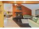 Stylish living room with fireplace, exposed beams, and an open design connecting to kitchen at 30444 Ruby Ranch Rd, Evergreen, CO 80439