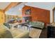 Inviting living room with a modern fireplace, high ceilings, exposed beams, and open access to kitchen at 30444 Ruby Ranch Rd, Evergreen, CO 80439