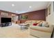 Cozy living room with plush seating, carpet flooring, and natural light from windows at 30444 Ruby Ranch Rd, Evergreen, CO 80439