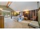 Bright main bedroom with wood-paneled accent wall and private balcony access at 30444 Ruby Ranch Rd, Evergreen, CO 80439