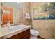 Charming powder room with decorative mirror, tile counter, and accent wall art at 30444 Ruby Ranch Rd, Evergreen, CO 80439