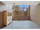 Bright sitting area featuring a large window with decorative glass and a stylish cabinet at 30444 Ruby Ranch Rd, Evergreen, CO 80439