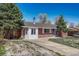 Charming single-story brick home featuring a well-maintained lawn and a private driveway at 8325 Elati St, Denver, CO 80221