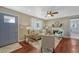 Cozy living room with hardwood floors, a ceiling fan, and abundant natural light at 8325 Elati St, Denver, CO 80221