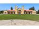 Classic building with red tile roof and arched doorways surrounded by a green lawn at 3132 E 17Th Ave # B, Denver, CO 80206