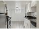 Kitchen featuring white cabinets, granite countertops, stainless steel appliances, and tile flooring at 3132 E 17Th Ave # B, Denver, CO 80206