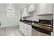 Kitchen featuring white cabinets, granite countertops, stainless steel appliances, and tile flooring at 3132 E 17Th Ave # B, Denver, CO 80206