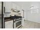 Kitchen featuring white cabinets, granite countertops, stainless steel appliances, and tile flooring at 3132 E 17Th Ave # B, Denver, CO 80206